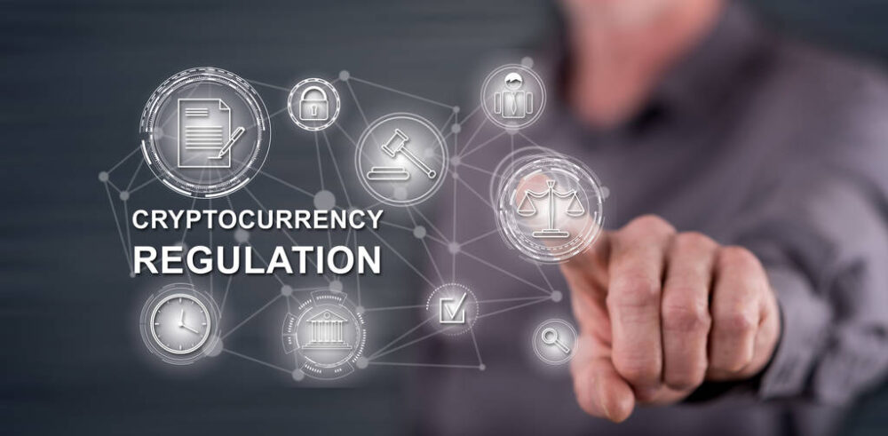 Man touching a cryptocurrency regulation concept on a touch screen with his finger