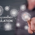 Man touching a cryptocurrency regulation concept on a touch screen with his finger